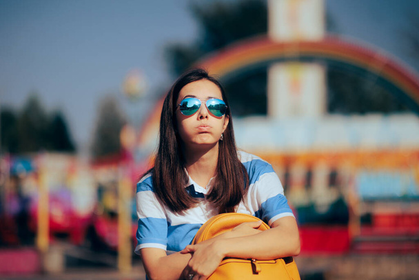 Unhappy Woman Holding Her Bag Waiting in a Funfair  - Foto, imagen