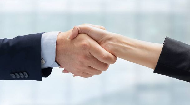 Close up of business people handshake in the office after meeting - Successful business man and business woman handshaking after good deal - isolated on white -  People Connection Deal Concept - Foto, afbeelding