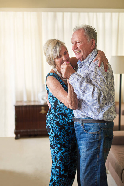 Olden love is golden love. a happy senior couple dancing together at home - Fotoğraf, Görsel