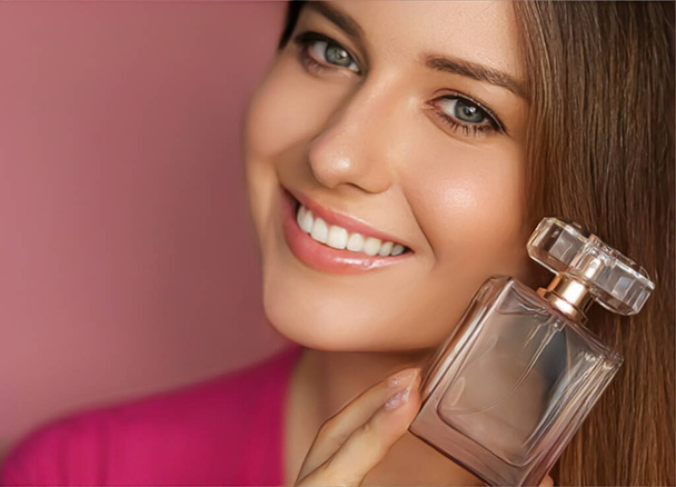 Perfume, beauty product and cosmetics model face portrait on pink background, beautiful woman holding fragrance bottle with floral feminine scent, fashion and makeup concept - Fotoğraf, Görsel