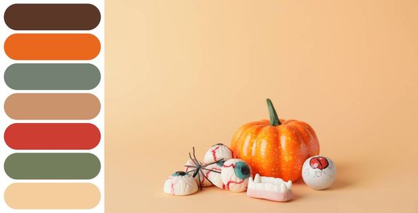 Tasty treats for Halloween on beige background. Different color patterns - Photo, Image