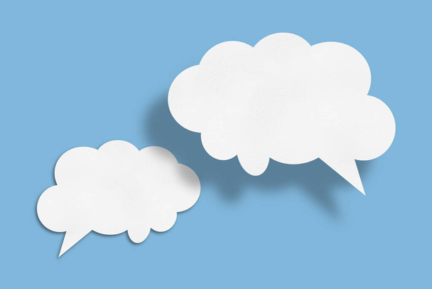 white cloud paper speech bubble shape against blue background design. - Valokuva, kuva