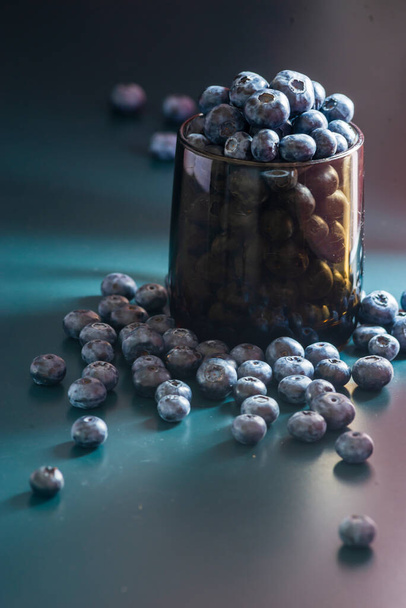Close-Up Fresh Blueberries blueberry BowlTable Freshly picked glass bowl. Juicy and fresh blueberries Bilberry dark food Background. antioxidant. Concept healthy eating nutrition fruit - Photo, image