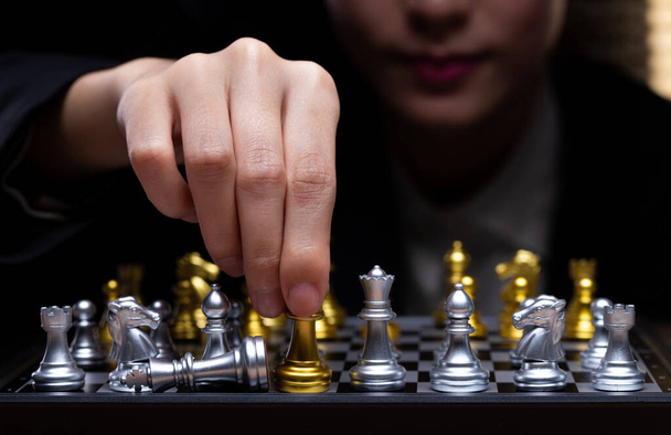 Business woman play Chess with close up Hand. Leader use strategy game to challenge competitor with intelligence leadership to move King to victory with management team idea fight, copy space - Fotografie, Obrázek