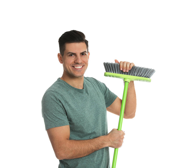 Man with green broom on white background - Foto, Bild