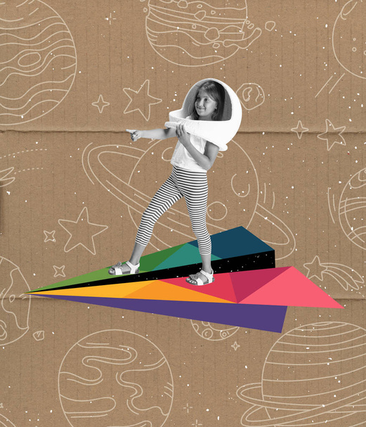 Exploring space. Creative artwork with little girl in huge white astronaut helmet flying on drawn colored aircraft over grey old paper effect background. Ideas, inspiration, imagination. Collage - 写真・画像