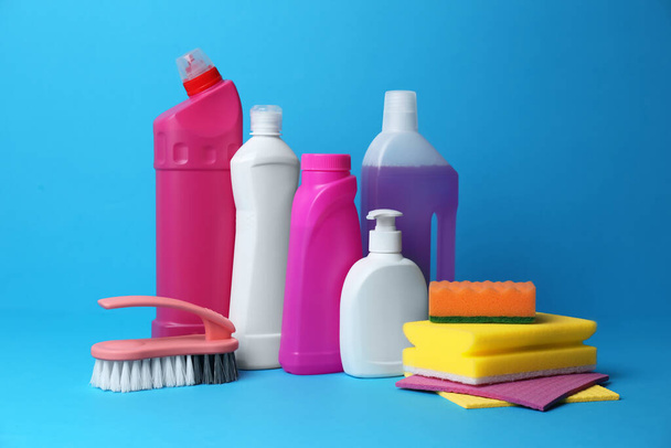 Cleaning supplies and tools on light blue background - Foto, Bild