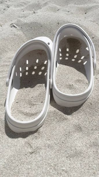 summertime and beach slippers on the sand - Fotoğraf, Görsel