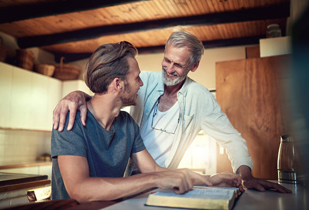 Everyone needs a spiritual mentor. a father and son doing Bible study together at home - Fotó, kép
