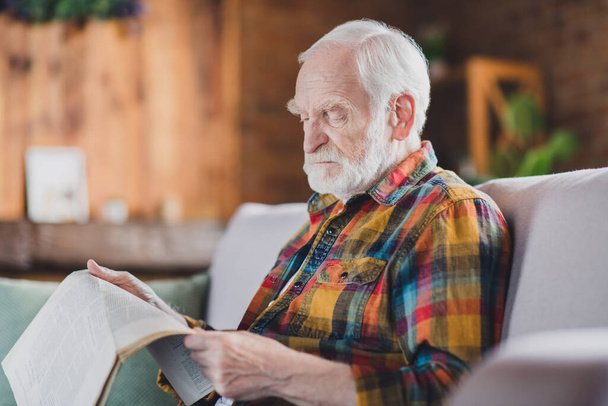 Photo of upset annoyed grandpa grey hair reading last taxes politics healthcare news wear casual checkered look sitting indoors home room. - Fotó, kép