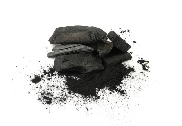 Activated carbon isolated. Active coal pile, absorbent charcoal closeup, graphite filter, absorb activated coal on white background - Zdjęcie, obraz