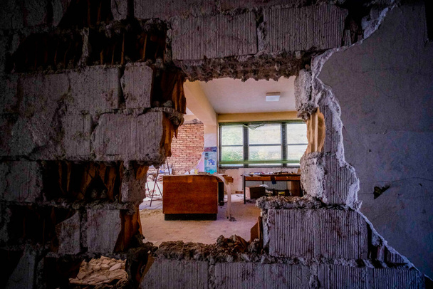 hole in the brick wall in large abandoned house. High quality photo - Foto, imagen