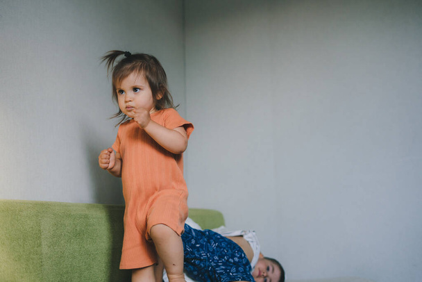 Children restless on the sofa waiting for their mother. Happy family, childhood. Smiling happy child. - Valokuva, kuva