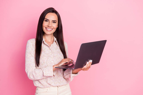 Photo of young attractive cute pretty woman professional programmer hold laptop isolated on pink color background. - Fotó, kép