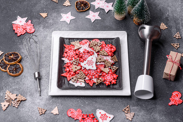 Christmas decorations and gingerbreads on a dark concrete table. Preparing and decorating the house for holiday - 写真・画像