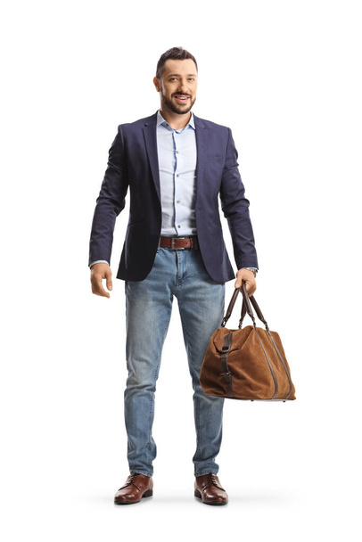 Full length portrait of a professional man carrying a bag isolated on white background - Фото, изображение