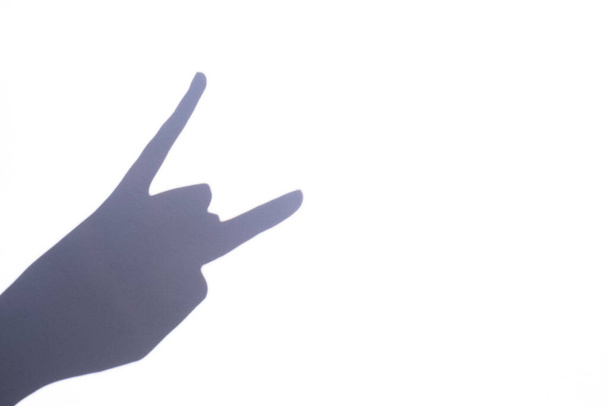 shadow gesture rock on white background, free space - Foto, Imagem