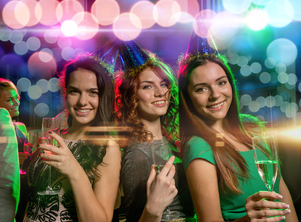 smiling friends with glasses of champagne in club - Photo, Image