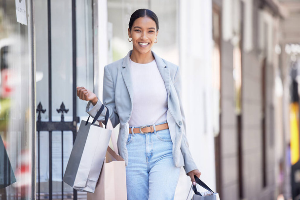 Fashion, retail and shopping with happy black woman excited about a sale, carry bag while walking in a city. Smiling female looking carefree, cheerful fun downtown, positive about discount on clothes. - Zdjęcie, obraz