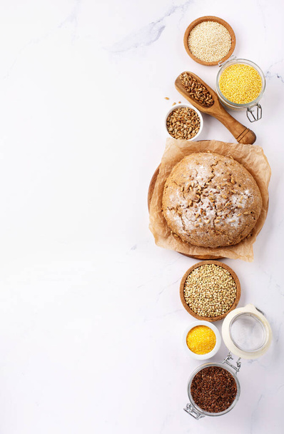 Ancient grain food. Gluten free Bread, Healthy eating, dieting, balanced food concept. Cereals gluten-free, millet, quinoa, polenta, buckwheat, flax seeds, sunflower seeds on white background. - Photo, image
