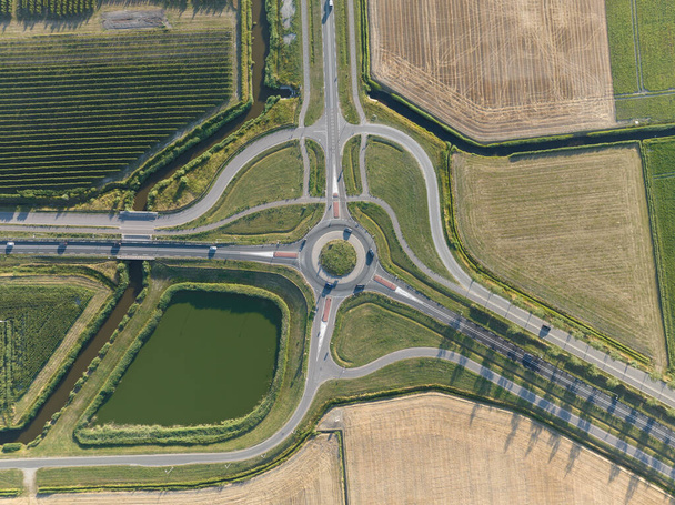 Roundabout junction aerial vehicle auto motorway intersection. Transportation safety crossroad. Circular ring road infrastructure street. - Photo, image