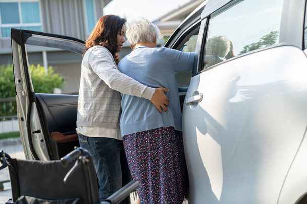 Caregiver help Asian senior or elderly old lady woman patient get to her car, healthy strong medical concept. - Fotografie, Obrázek