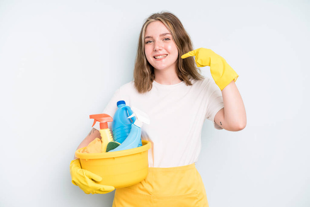 caucasian pretty woman smiling confidently pointing to own broad smile. housekeeper cleaning concept - Foto, Bild