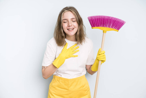 caucasian pretty woman laughing out loud at some hilarious joke. housekeeper cleaning concept - Φωτογραφία, εικόνα