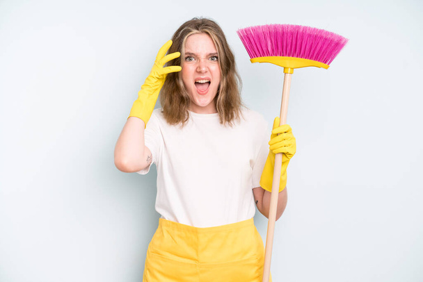 caucasian pretty woman screaming with hands up in the air. housekeeper cleaning concept - Zdjęcie, obraz