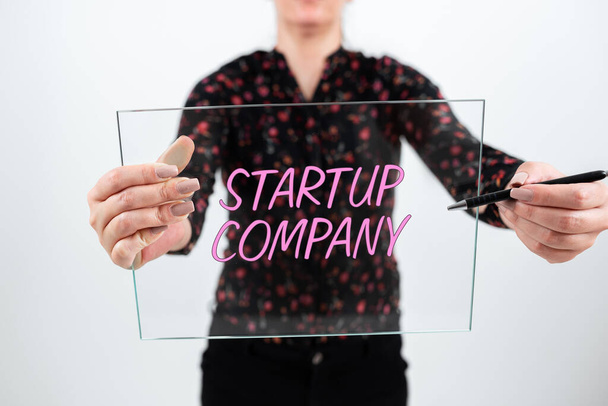 Znak tekstowy pokazujący Startup Company, Business approach Nowo powstały biznes stworzony przez nowych przedsiębiorców Biznesmen w garniturze z otwartą dłonią symbolizującym udaną pracę zespołową. - Zdjęcie, obraz