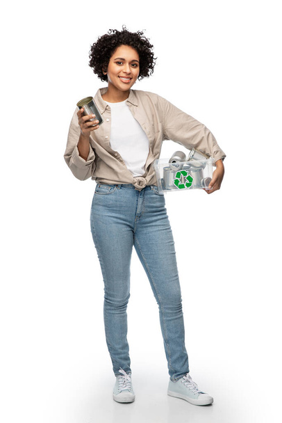 metal recycling, waste sorting and sustainability concept - happy woman holding plastic box with tin cans over white background - Foto, Bild