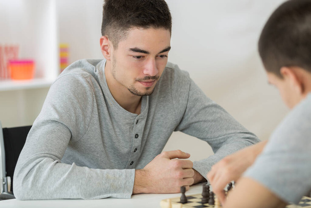 portrait of two young man playing chess - Foto, Imagem