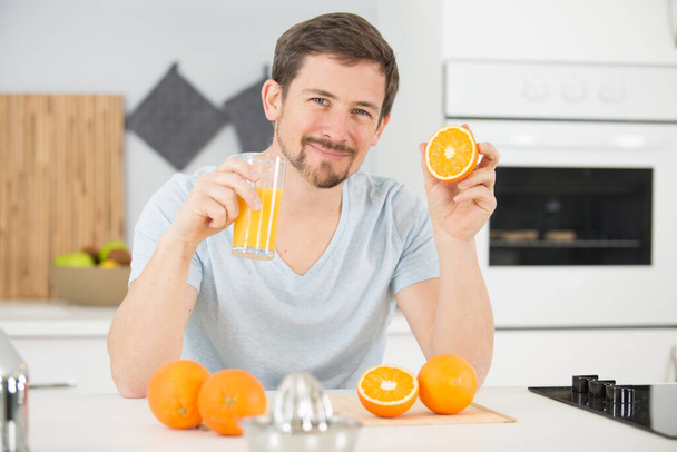 happy man drinking orange juice - Фото, изображение