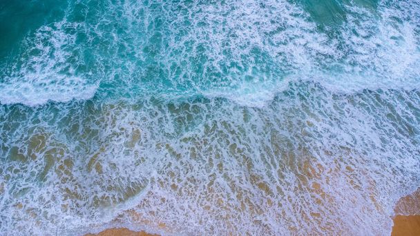 Beautiful sea waves and white sand beach in the tropical island. Soft waves of blue ocean on sandy beach background from top view from drones. Concept of relaxation and travel on vacation. - Photo, image