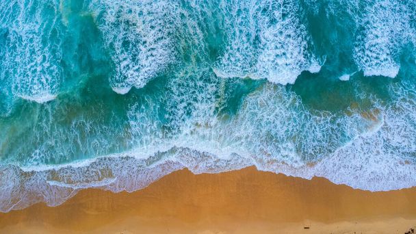 Beautiful sea waves and white sand beach in the tropical island. Soft waves of blue ocean on sandy beach background from top view from drones. Concept of relaxation and travel on vacation. - Fotoğraf, Görsel