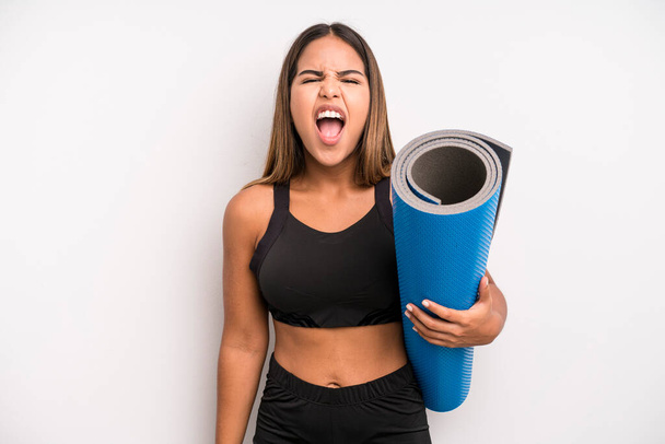 hispanic pretty woman shouting aggressively, looking very angry. fitness and yoga concept - Φωτογραφία, εικόνα
