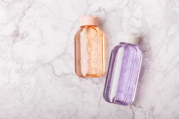 Face care for the face, tonic or lotion, micellar water on a marble background.Beauty concept.Freshness and naturalness Anti-aging care. Women's daily fresh cosmetics. Copy space. Flat lay. - 写真・画像