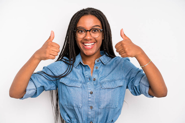black young adult woman smiling broadly looking happy, positive, confident and successful, with both thumbs up - Fotoğraf, Görsel