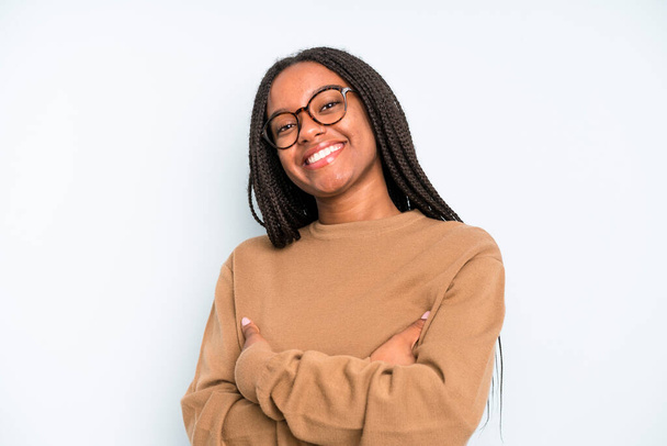 black young adult woman laughing happily with arms crossed, with a relaxed, positive and satisfied pose - Photo, Image