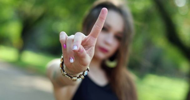 Attractive young woman blocking with hand and gesturing NO with finger. Stop signal - Photo, Image