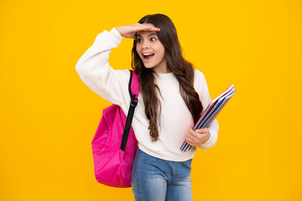 School teenage girl with book and copybook. Teenager schoolgirl student, isolated background. Learning and knowledge. Go study. Education concept. Excited teenager girl - Foto, afbeelding
