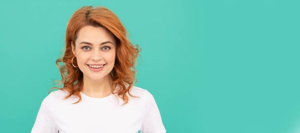 happy redhead woman with curly hair on blue background. Woman isolated face portrait, banner with copy space - Photo, Image