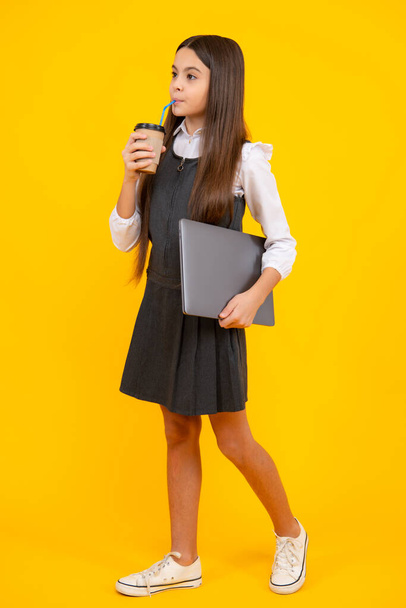 Teenage girl with take away cup of cappuccino coffee or tea. Child with takeaway cup on yellow background, morning drink beverage - Photo, image