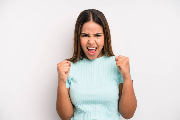 hispanic latin pretty woman feeling shocked, excited and happy, laughing and celebrating success, saying wow! - Photo, image