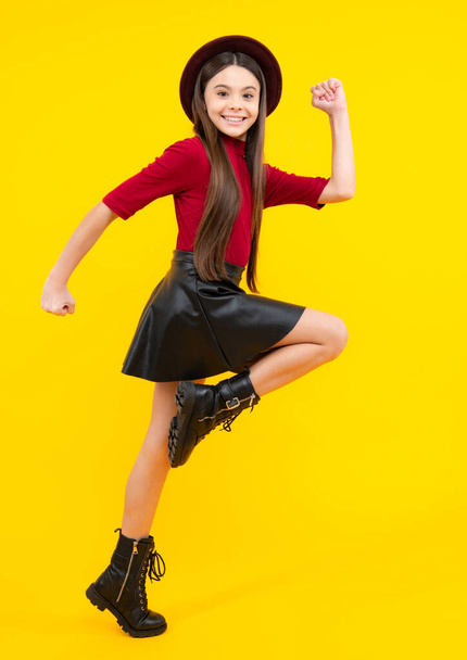 Full size walk on isolated studio wear hat, casual wear, fashion skirt and shoes. Happy teenager portrait. Smiling girl - Foto, Bild