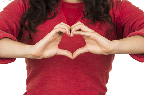 young girl wearing red top posing making a heart with hands - Foto, immagini