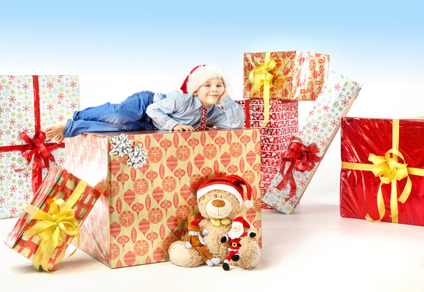 Little cute boy with plenty of gifts - Foto, afbeelding