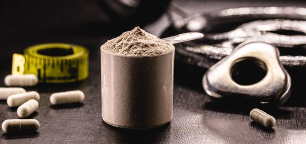 Measuring Spoon with Creatine or Whey, Food Supplement, Casein Cocktail, Muscle Mass Vitamin, Plated, Bodybuilding Concept - Photo, Image