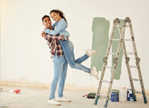Love, a mortgage and a new home, couple paint a wall in a house green. Security, home finance and investment, a happy marriage and family fun. New beginning and bright future for young man and woman - Foto, Imagen