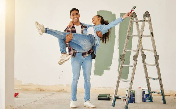 Diy, home improvement and wall painting with happy couple renovating house and having fun together. Playful husband and wife being silly and goofy, enjoying their relationship and project together. - Foto, Imagen